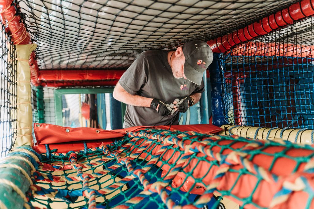 installing obstacle course at indoor playground